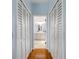 Hallway with white shutters and wood floors at 341 Perfect Dr, Daytona Beach, FL 32124