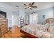 Main bedroom with wood floors, large bed, and ceiling fan at 341 Perfect Dr, Daytona Beach, FL 32124