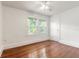 Bedroom featuring hardwood floors, a ceiling fan, two windows, and a closet at 724 N Oleander Ave, Daytona Beach, FL 32118