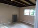 Bedroom featuring tiled floors, and a large window at 724 N Oleander Ave, Daytona Beach, FL 32118