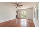 Bright room featuring hardwood floors, ceiling fan, and double doors at 724 N Oleander Ave, Daytona Beach, FL 32118