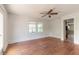 Bright room featuring hardwood floors, ceiling fan and large window at 724 N Oleander Ave, Daytona Beach, FL 32118