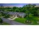 Aerial view of townhomes with manicured lawns and mature trees backing up to a tranquil pond at 34 Fairway Dr # 1, Debary, FL 32713