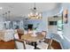 Bright dining area with a wooden table and view into living room at 702 Victory Ln, Port Orange, FL 32128