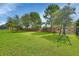 Spacious backyard with grassy lawn, and play equipment at 257 Ancona Ave, Debary, FL 32713