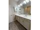 Double vanity bathroom with white cabinets and a large mirror at 257 Ancona Ave, Debary, FL 32713
