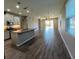 Open-concept kitchen and living area with wood-look floors at 257 Ancona Ave, Debary, FL 32713