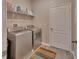 Convenient laundry room with washer, dryer, and shelving at 257 Ancona Ave, Debary, FL 32713