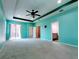 Main bedroom with teal walls, carpet, and access to backyard at 257 Ancona Ave, Debary, FL 32713