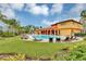 Community pool with clubhouse and palm trees at 257 Ancona Ave, Debary, FL 32713