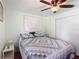 Relaxing bedroom features a comfortable bed, ceiling fan, and soft lighting, providing a tranquil retreat within the home at 824 Silver Oak Ave, The Villages, FL 32159