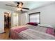 Comfortable bedroom featuring a ceiling fan, window with blinds, and easy access to the ensuite bathroom and walk-in closet at 824 Silver Oak Ave, The Villages, FL 32159