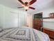 Comfortable bedroom showcasing a cozy bed, wooden dresser, and ceiling fan, creating a relaxing and inviting atmosphere at 824 Silver Oak Ave, The Villages, FL 32159