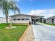 Charming single-story home with a well-manicured lawn, covered carport, and inviting curb appeal at 824 Silver Oak Ave, The Villages, FL 32159