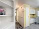 Hallway with access to kitchen and features a wall railing, golf magazine rack and carpet at 824 Silver Oak Ave, The Villages, FL 32159