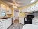 A bright and sunny kitchen featuring plenty of cabinet space, an oven, and an undermount sink at 824 Silver Oak Ave, The Villages, FL 32159