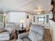 Inviting living room with comfortable seating and a view of the adjacent dining area at 824 Silver Oak Ave, The Villages, FL 32159