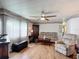 Cozy living room with comfortable seating and beautiful hardwood floors, perfect for relaxing at 824 Silver Oak Ave, The Villages, FL 32159