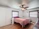 Well-lit main bedroom with hardwood floors, ceiling fan and built in shelving at 824 Silver Oak Ave, The Villages, FL 32159