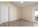 Bright bedroom with wood-look tile floors and sliding glass door at 3435 Arabesque Dr, Deland, FL 32724