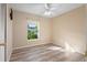 Well-lit bedroom featuring wood-look floors and a window at 3435 Arabesque Dr, Deland, FL 32724