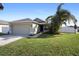 One-story house with attached garage and a well-maintained lawn at 3435 Arabesque Dr, Deland, FL 32724