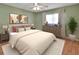 Bedroom featuring a queen-sized bed, wooden floors and neutral decor at 47 Villa Villar Ct # 470, Deland, FL 32724