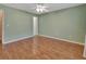 Large bedroom featuring wooden floors and a ceiling fan at 47 Villa Villar Ct # 470, Deland, FL 32724