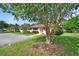 Charming home featuring manicured landscaping and a healthy tree at 47 Villa Villar Ct # 470, Deland, FL 32724