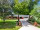 Charming brick home featuring a long driveway and lush landscaping, creating a welcoming curb appeal at 106 N Frederick St, Pierson, FL 32180