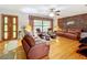 Inviting living room with brick accent wall, hardwood floors, and leather furniture, illuminated by natural light at 106 N Frederick St, Pierson, FL 32180