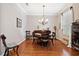 Formal dining room features hardwood floors and chandelier at 210 Brookgreen Way, Deland, FL 32724