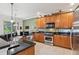 Modern kitchen with wood cabinets and granite countertops at 210 Brookgreen Way, Deland, FL 32724