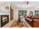 Living room with fireplace, hardwood floors and view to backyard at 210 Brookgreen Way, Deland, FL 32724