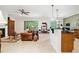 Spacious living room with a leather sofa and a view into the kitchen at 210 Brookgreen Way, Deland, FL 32724