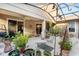 Inviting patio with covered seating area and lush potted plants at 210 Brookgreen Way, Deland, FL 32724