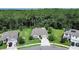 Scenic aerial view of a home with a spacious yard, lush green trees, and a cul-de-sac street at 317 Nowell Loop, Deland, FL 32724