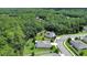 Aerial view of a community with mature trees and several properties with solar panels at 317 Nowell Loop, Deland, FL 32724
