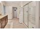 Bathroom featuring a shower with glass doors, tiled floors, and a granite countertop at 317 Nowell Loop, Deland, FL 32724