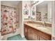 Bathroom featuring double sinks, granite countertop, bathtub with nautical themed shower curtain at 317 Nowell Loop, Deland, FL 32724