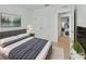Comfortable bedroom with neutral tones, a cozy bed, and easy access to other rooms at 317 Nowell Loop, Deland, FL 32724