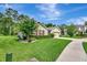 Charming home with lush landscaping, mature trees, and well-maintained lawn at 317 Nowell Loop, Deland, FL 32724