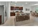 Spacious kitchen with an island, dark wood cabinets, stainless steel appliances, and an adjacent dining area at 317 Nowell Loop, Deland, FL 32724
