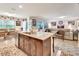 Open concept kitchen with granite island, dark wood cabinets, and stainless steel dishwasher at 317 Nowell Loop, Deland, FL 32724