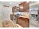 A kitchen featuring dark wood cabinets, granite countertops and stainless steel appliances at 317 Nowell Loop, Deland, FL 32724