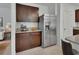 Well-equipped kitchen with dark wood cabinetry, stainless steel appliances, and granite countertops for meal preparation at 317 Nowell Loop, Deland, FL 32724