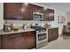 Stylish kitchen with dark wood cabinets, stainless steel appliances, granite countertops, and tile backsplash at 317 Nowell Loop, Deland, FL 32724