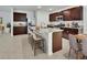 Modern kitchen with stainless steel appliances, dark cabinets, and a large island with seating at 317 Nowell Loop, Deland, FL 32724