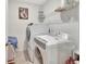 Bright laundry room with washer, dryer, shelving, and decor at 317 Nowell Loop, Deland, FL 32724