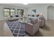 Bright living room with comfortable seating, stylish rug, and plenty of natural light at 317 Nowell Loop, Deland, FL 32724